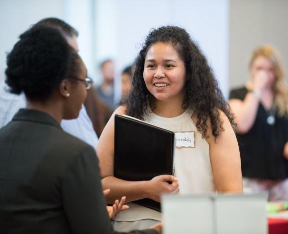 Student speaking with employer at Meet the Firms day